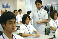 Matsumoto teaching proper body position to first year students in “Acupuncture and Moxibustion Technique I” 