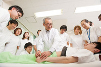 Oura teaching needle insertion to second year students in “Acupuncture and Moxibustion Technique II B”